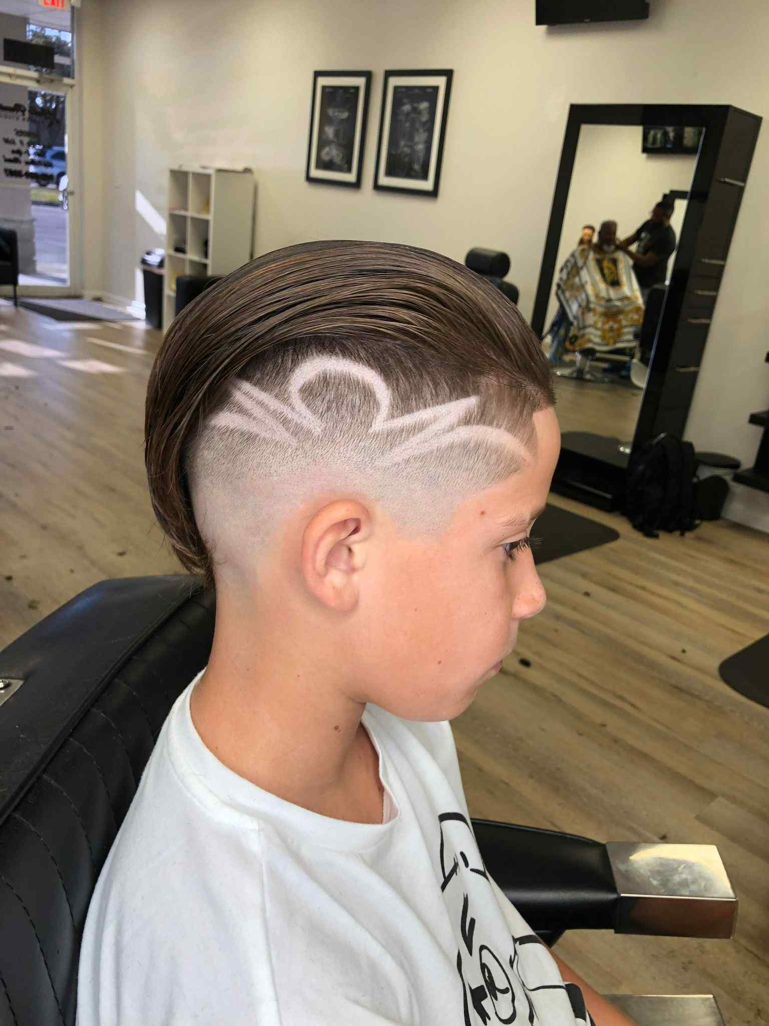 Kids haircut with a custom shaved design by a Lake Wales barber