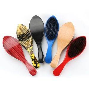 A collection of six Marathon Wave Brushes, each featuring a unique design and color—including red, yellow camouflage, black, blue, wood grain, and red-and-black mixed bristle patterns—arranged in a fan shape. Perfect for any barber in Bartow seeking a stylish set.